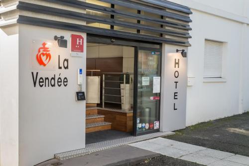 a store front with the front door open at Hôtel de la Vendée in La Roche-sur-Yon