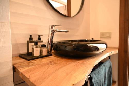 a bathroom with a black sink on a wooden counter at Somptueuse Family Villa Cherifa avec piscine in Marrakech
