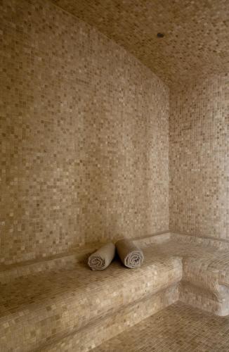 a corner of a room with two pillows on a tub at Grand Hotel Des Sablettes Plage, Curio Collection By Hilton in La Seyne-sur-Mer