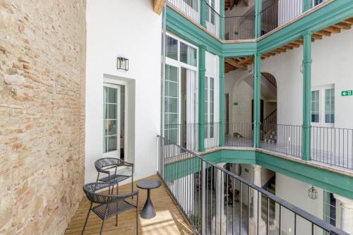 a view of the balcony of a building with two chairs at Palacio Vegafuente by Caleta Homes in Málaga