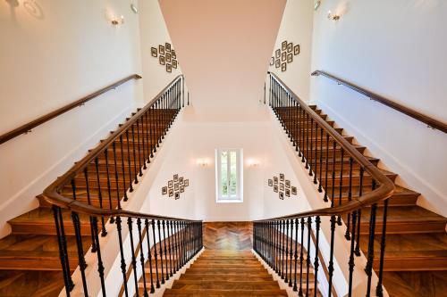 a staircase in a house with wooden floors at Grand Hotel Des Sablettes Plage, Curio Collection By Hilton in La Seyne-sur-Mer