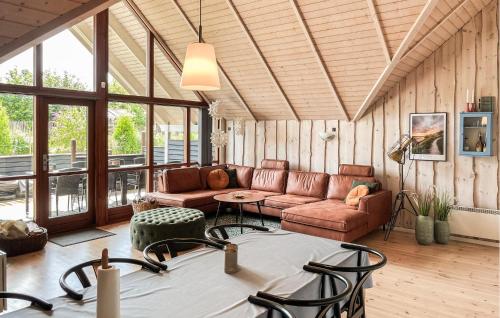 a living room with a couch and a table at Holiday Home Lindevænget Humble Iv in Humble