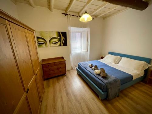 a bedroom with a bed with shoes on it at Sh Suite Borgo in Bracciano
