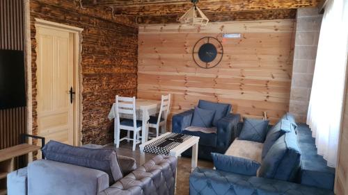 a living room with blue couches and a table at Zagrad Homes in Zabljak in Žabljak