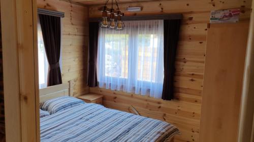 a bedroom with a bed in a log cabin at Zagrad Homes in Zabljak in Žabljak