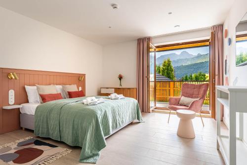 a bedroom with a bed and a balcony at Apartamenty Mikołaj Zakopane in Kościelisko