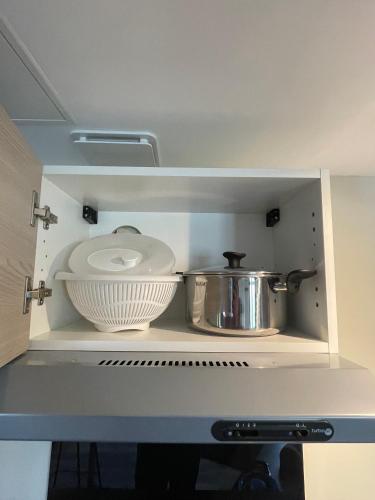 a kitchen with a shelf with a pot and pans at Plage des Sables d'or in Broons