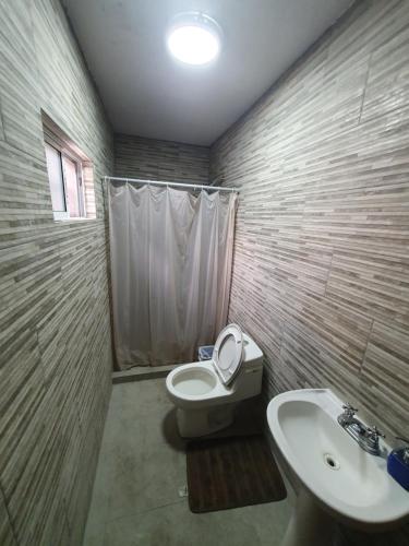 a bathroom with a toilet and a sink at Habitacion Matrimonial in Monterrey
