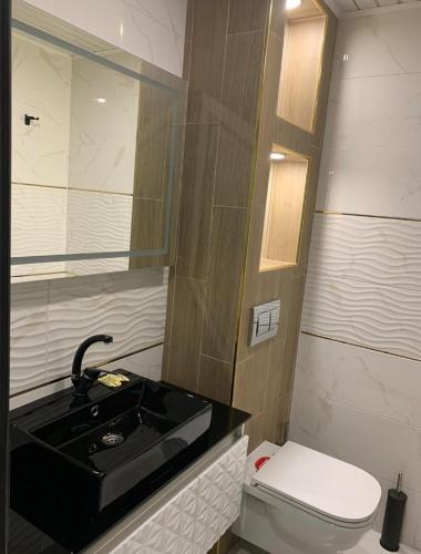 a bathroom with a black sink and a toilet at Българе in Vratsa