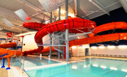 a swimming pool with a red water slide at Semi detached quite location in Bridlington
