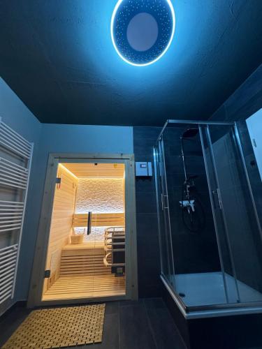 a bathroom with a shower and a light on the ceiling at Ferienwohnung HarzReise in Braunlage