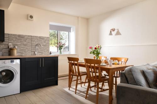 a kitchen and living room with a table and chairs at The Old Stable in Bridlington