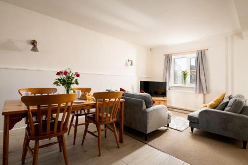 a living room with a table and chairs and a couch at The Old Stable in Bridlington