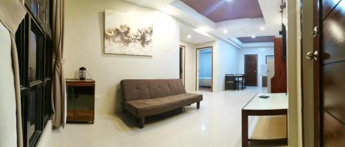 a living room with a couch and a table at Hotel Elegant La Union in San Fernando