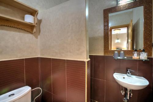 a bathroom with a sink and a mirror at Riad Inaka in Marrakech