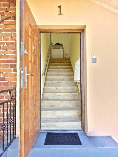 a staircase leading up to a building with a door at Zacisze Mazurskie nad Jeziorem in Sędańsk