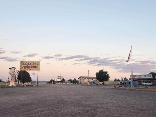 a parking lot with a sign and a sign for a motel at Prairie Falcon 4 in Valle