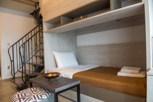 a small room with a bunk bed and a staircase at Chasapis Luxury Apartments&Studios in Vourvourou
