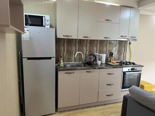 a kitchen with a white refrigerator and a sink at Sayat-Nova Apartments Yerevan in Yerevan