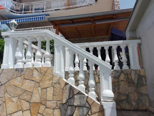 eine Treppe mit weißen Geländern an einem Haus in der Unterkunft Apartman Rahela in Selce