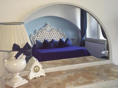a bedroom with a bed with a large mirror at Villa Neptunus in Ischia