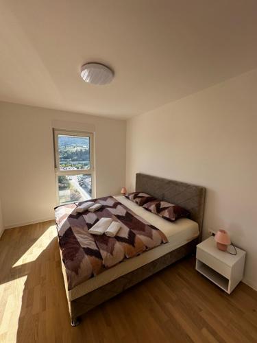 a bedroom with a large bed and a window at Apartment Ivan in Mostar