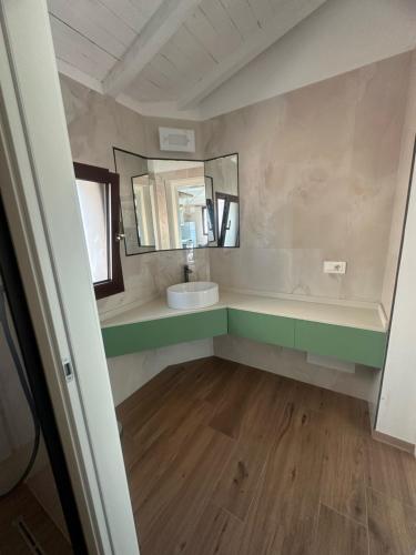 a bathroom with a sink and a mirror at La Vecchia cantina Guzzardi in Lari