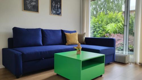 a blue couch and a green coffee table in a living room at Lego Fans Аpartment #3 Billund Center in Billund