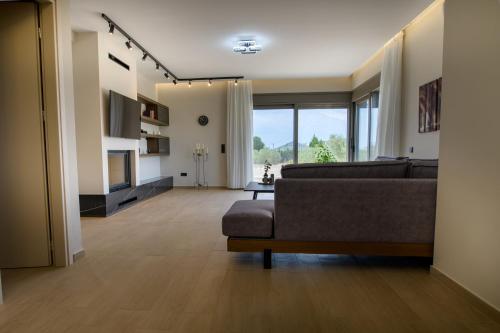 a living room with a couch and a large window at Villa Niki in Alexandroupoli