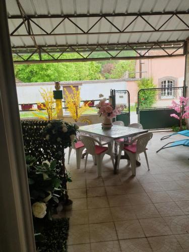 a patio with a table and chairs on a patio at FLORIDE in Le Mériot