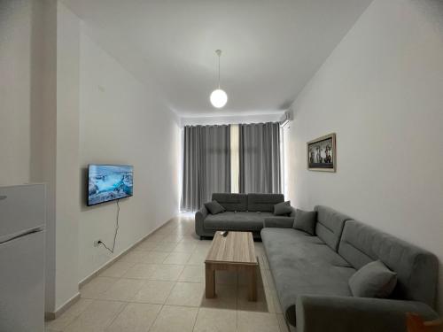 a living room with a couch and a table at Ameti - Ground Floor Comfort Suites - Spacious & Modern in Orikum