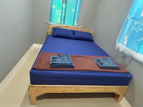 a bed in a room with a blue mattress at Noot's Guesthouse in Kanchanaburi
