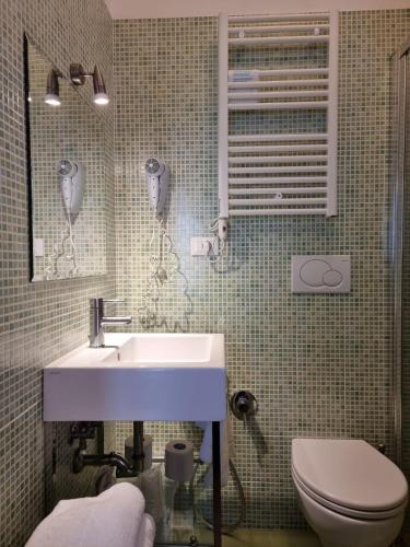 a bathroom with a sink and a toilet at Hotel Morena in Lido di Jesolo