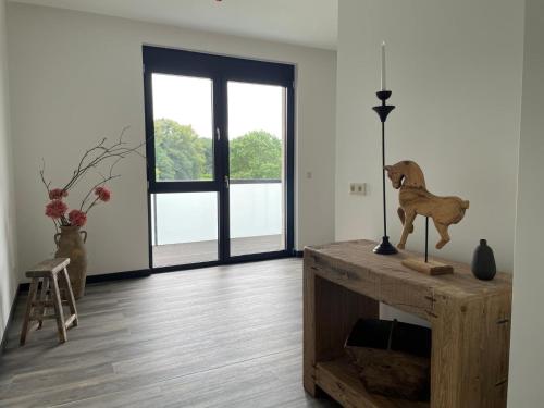 a room with a table with a horse statue on it at Schloss Rattey - Haus WeinWerk in Schönbeck