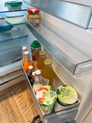 an open refrigerator filled with lots of food and drinks at Bed & Breakfast Danina in Sassenheim