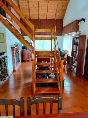 a wooden staircase in a room with a living room at Casa de Playa in Santa Clara del Mar