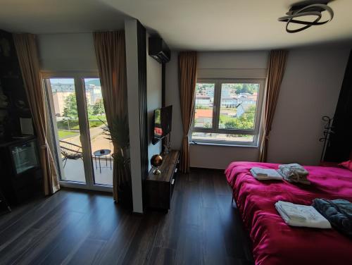 a hotel room with a bed and two windows at Diamond Stan na Dan in Kiseljak