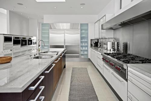 a large kitchen with a sink and a stove at Winding Way in Malibu