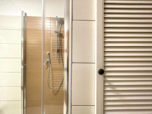 a shower in a bathroom with a glass door at Forest Oasis Studio - free Netflix and Disney Plus in Predeal