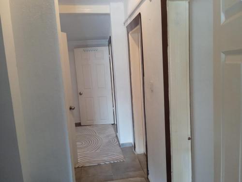 a hallway with a white door and a rug at Ernur Pension in Canakkale