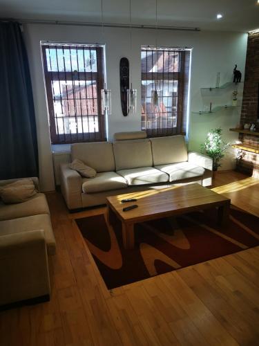 a living room with a couch and a coffee table at Pekný dom s parkovaním in Pribylina