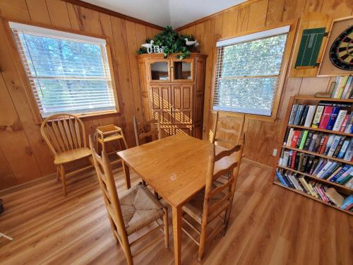 a dining room with a wooden table and chairs at Barney's Roost in Sanderling
