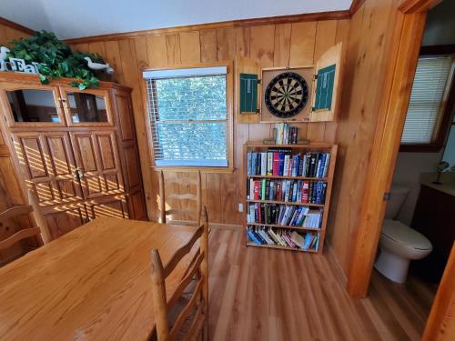 a dining room with a table and a book shelf at Barney's Roost in Sanderling