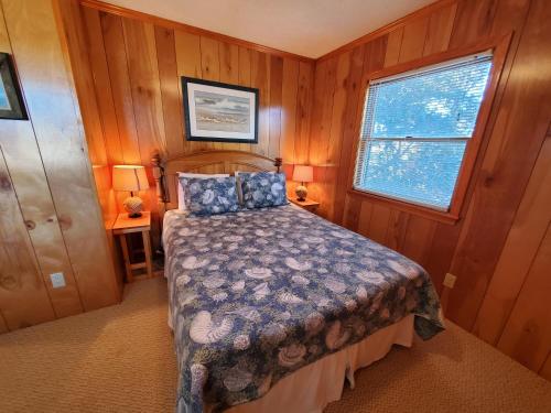 a bedroom with a bed and a window at Barney's Roost in Sanderling