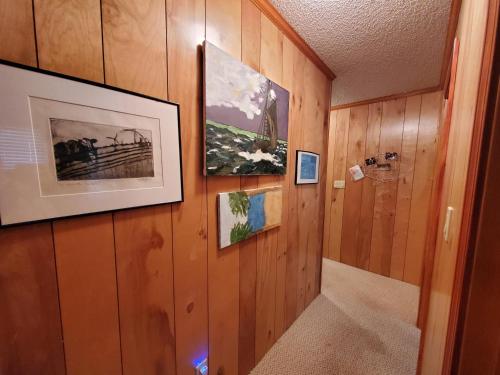 a hallway with wood paneling and pictures on the wall at Barney's Roost in Sanderling