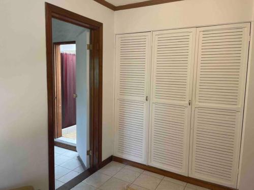 a room with white closets and a mirror at Green place apartament in Quesada