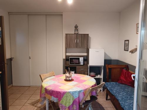 a kitchen with a table and a refrigerator at Chambre les flamants, climatisation, avec vue imprenable sur les étangs, petit déjeuner offert in Saintes-Maries-de-la-Mer