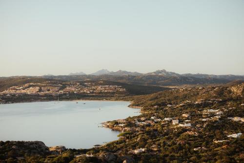 an aerial view of a lake with houses and mountains at NUALI - Stazzo in Gallura in Palau