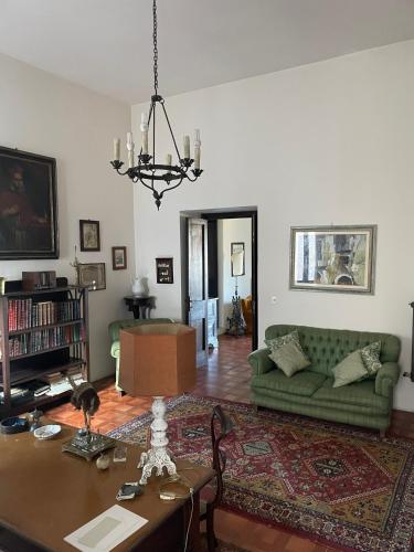 a living room with a green couch and a table at Residenza del Castello di Fornelli in Fornelli