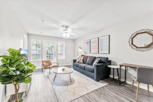 a living room with a couch and a table at Spacious 2BR King Suites w Pool, Gym, Laundry - Close to Downtown in Austin
